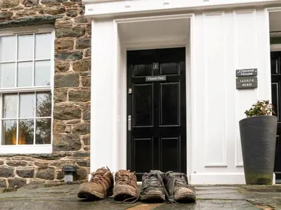 a group of shoes sitting in front of a door at 2 Bed in Keswick oc-sz132 in Keswick
