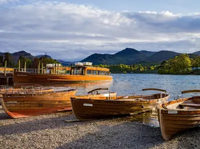 three boats sitting on the shore of a lake at 2 Bed in Keswick oc-sz132 in Keswick