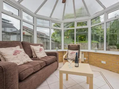 a conservatory with a couch and a table at 3 Bed in Keswick oc-sz283 in Keswick