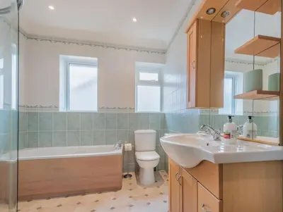 a bathroom with a sink and a toilet and a tub at 3 Bed in Keswick oc-sz283 in Keswick