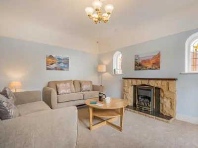 a living room with a couch and a fireplace at 3 Bed in Keswick oc-sz283 in Keswick