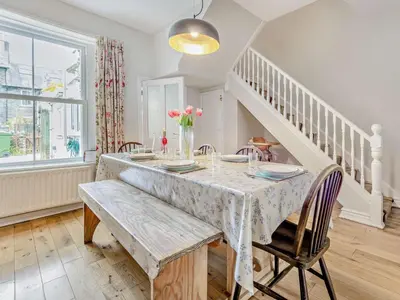 a dining room with a table with a vase of flowers at 3 Bed in Keswick oc-sz545 in Keswick