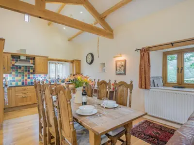 a kitchen and dining room with a wooden table and chairs at 2 Bed in Patterdale SZ470 in Patterdale