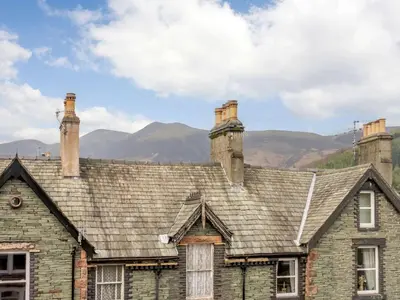 an old stone house with two chimneys on top of it at 3 Bed in Keswick oc-sz118 in Keswick