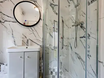 a bathroom with a shower and a sink and a mirror at 2 Bed in Keswick oc-sz417 in Keswick