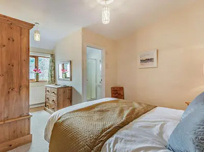 a bedroom with a bed and a dresser and a window at 3 Bed in Keswick oc-sz153 in Braithwaite