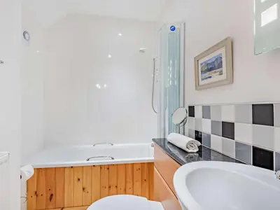 a bathroom with a tub and a toilet and a sink at 3 Bed in Keswick oc-sz153 in Braithwaite