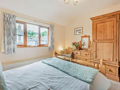 a bedroom with a bed and a dresser and a window at 3 Bed in Keswick oc-sz153 in Braithwaite