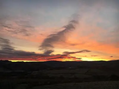 a sunset in a field with a cloudy sky at 3 Bed in Penrith oc-sz247 in Dockray
