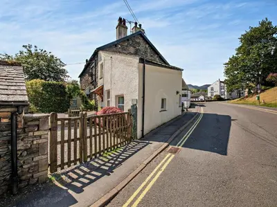 a small white building on the side of a street at 2 Bed in Keswick oc-sz145 in Braithwaite
