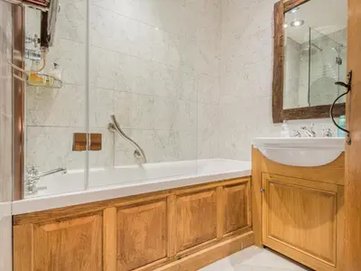 a bathroom with a tub and a sink and a shower at 5 Bed in Holmrook oc-sz259 in Eskdale
