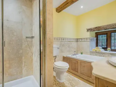 a bathroom with a toilet and a tub and a sink at 5 Bed in Holmrook oc-sz259 in Eskdale