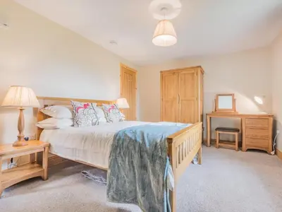 a bedroom with a large bed and a desk at 3 Bed in Keswick oc-sz227 in Threlkeld