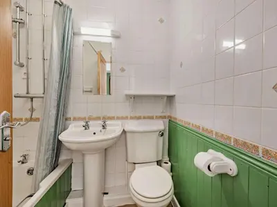 a bathroom with a white toilet and a sink at 2 Bed in Keswick SZ027 in Keswick
