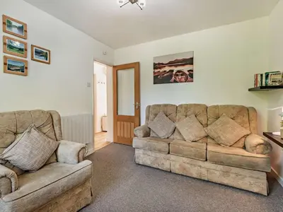 a living room with a couch and a chair at 2 Bed in Keswick SZ027 in Keswick