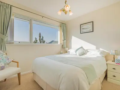 a bedroom with a bed and a window and a chair at 1 Bed in Keswick oc-sz437 in Keswick