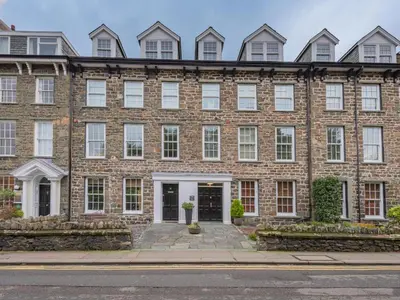 a large brick building with white doors and windows at 2 Bed in Keswick SZ494 in Keswick