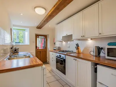a kitchen with white cabinets and a counter top at 2 Bed in Keswick oc-sz378 in Portinscale
