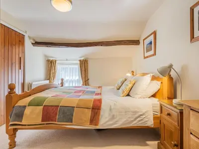 a bedroom with a large bed and a desk at 2 Bed in Keswick oc-sz378 in Portinscale