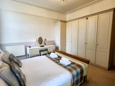 a bedroom with a bed and a desk with a mirror at 2 Bed in Holmrook oc-sz464 in Beckfoot