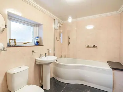 a bathroom with a tub and a toilet and a sink at 2 Bed in Holmrook oc-sz464 in Beckfoot