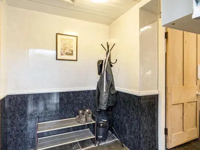 a hallway with a shelf and shoes on a wall at 2 Bed in Holmrook oc-sz464 in Beckfoot