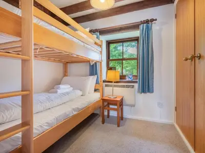 a bedroom with two bunk beds and a desk at 2 Bed in Penrith oc-sz218 in Mosedale