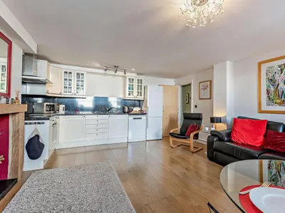 a living room with a couch and a kitchen at 1 Bed in Keswick SZ127 in Keswick