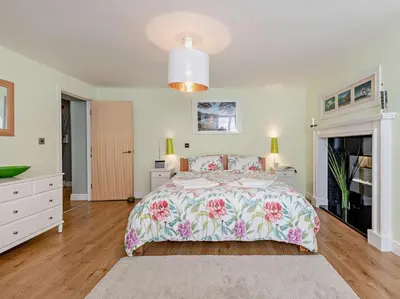 a bedroom with a bed with a floral bedspread at 1 Bed in Keswick SZ127 in Keswick