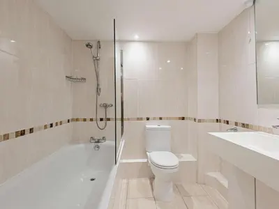 a bathroom with a toilet and a tub and a sink at 1 Bed in Keswick SZ127 in Keswick