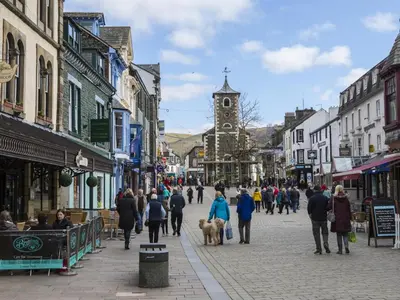a group of people walking down a city street at 3 Bed in Keswick oc-sz029 in Keswick