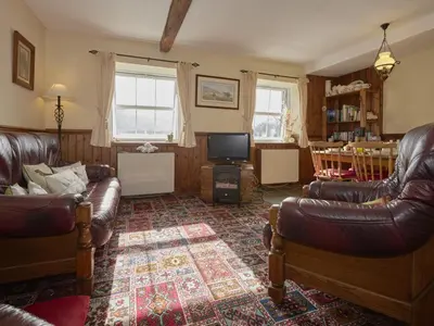 a living room with leather furniture and a television at 2 Bed in Wasdale Head oc-sz551 in Nether Wasdale