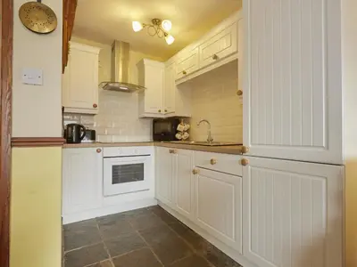 a kitchen with white cabinets and a sink at 2 Bed in Wasdale Head oc-sz551 in Nether Wasdale
