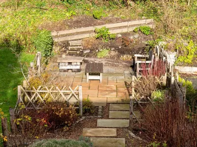 a garden with a stone path with a bench at 3 Bed in Keswick oc-sz337 in Keswick