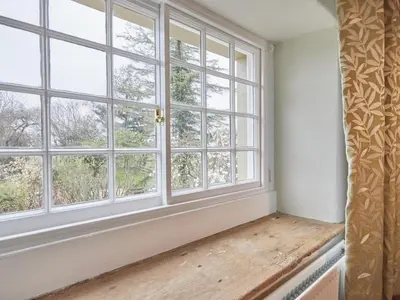 an empty room with windows and a wooden bench at 3 Bed in Keswick oc-sz169 in Applethwaite