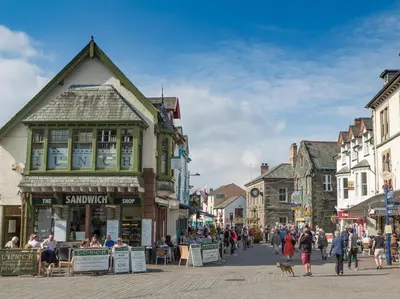 a group of people walking down a street in a town at 3 Bed in Keswick oc-sz169 in Applethwaite
