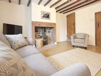 a living room with a couch and a fireplace at 3 Bed in Keswick oc-sz169 in Applethwaite