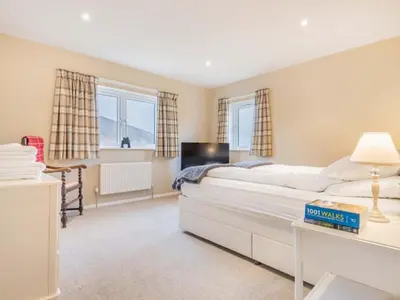a bedroom with a large white bed and two windows at 4 Bed in Newlands Valley SZ204 in Braithwaite