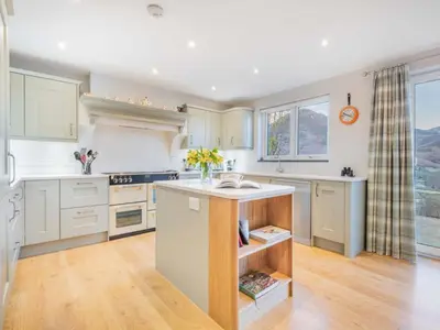 a kitchen with white cabinets and a sink at 4 Bed in Newlands Valley SZ204 in Braithwaite