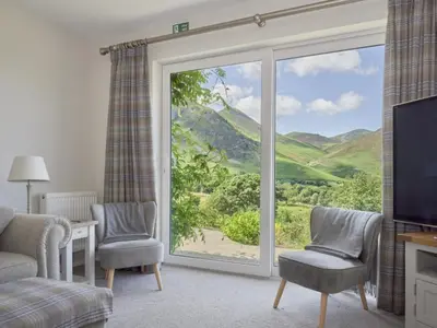 a living room with a large sliding glass door at 4 Bed in Newlands Valley SZ204 in Braithwaite