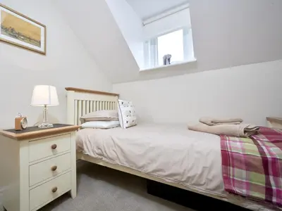 a bedroom with a bed with a lamp and a window at 4 Bed in Keswick oc-sz220 in Keswick