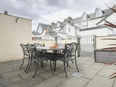 a table and chairs sitting on a patio at 4 Bed in Keswick oc-sz220 in Keswick