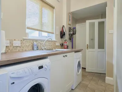 a kitchen with a washing machine and a sink at 4 Bed in Keswick oc-sz220 in Keswick