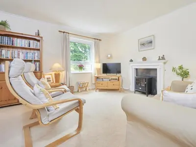 a living room with a chair and a fireplace at 2 Bed in Keswick oc-sz188 in Keswick
