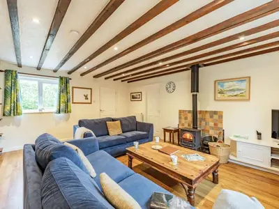 a living room with a blue couch and a table at 3 Bed in Keswick oc-sz335 in Portinscale