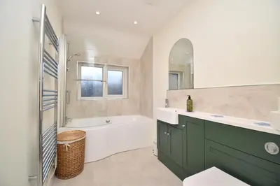 a bathroom with a white tub and a sink at 3 Bed in Keswick oc-sz335 in Portinscale