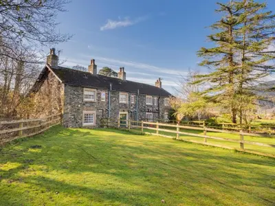 an old stone house with a fence and a yard at 2 Bed in Keswick oc-sz199 in Applethwaite