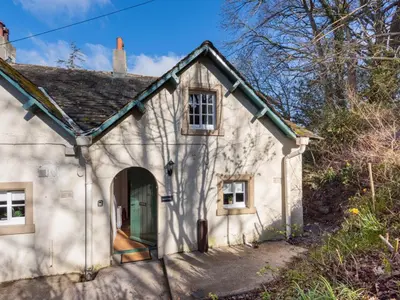 a small white house with a door and a window at 2 Bed in Keswick oc-sz199 in Applethwaite