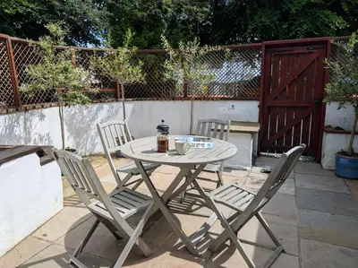 a table and two chairs sitting on a patio at 2 Bed in Keswick oc-sz279 in Keswick