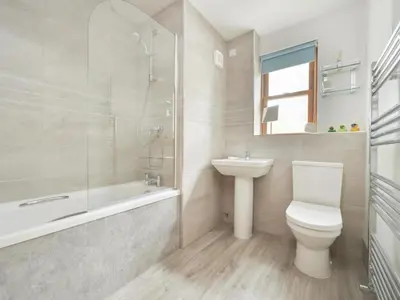 a bathroom with a toilet and a sink and a bath tub at 2 Bed in Keswick oc-sz279 in Keswick